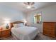 Bright bedroom with a ceiling fan, neutral walls, wood furniture, and a sunny window at 4264 S Columbine Way, Gold Canyon, AZ 85118