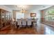 Bright dining room with wood floors, a large window, and seating for six at 4264 S Columbine Way, Gold Canyon, AZ 85118