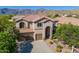 Charming two-story home featuring a tile roof, three-car garage, and landscaped front yard with mountain views at 4264 S Columbine Way, Gold Canyon, AZ 85118