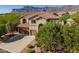 Charming two-story home featuring a tile roof, three-car garage, and landscaped front yard with mountain views at 4264 S Columbine Way, Gold Canyon, AZ 85118