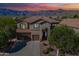 Charming two-story home featuring a tile roof, three-car garage, and landscaped front yard with mountain views at 4264 S Columbine Way, Gold Canyon, AZ 85118