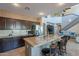Spacious kitchen with tile floors, a breakfast bar, and access to an upstairs living area at 4264 S Columbine Way, Gold Canyon, AZ 85118