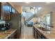 Spacious kitchen showcasing granite countertops, stainless steel appliances, and seamless access to the living room at 4264 S Columbine Way, Gold Canyon, AZ 85118