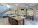 Open kitchen featuring granite counters, island, eat-in area, and seamless access to the living room and outdoor pool at 4264 S Columbine Way, Gold Canyon, AZ 85118