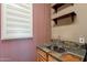 Charming laundry room with checkered wallpaper, ample counter space, and shelving at 4264 S Columbine Way, Gold Canyon, AZ 85118
