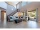 Bright, open living room with two-story windows, tile floors, and sliding doors at 4264 S Columbine Way, Gold Canyon, AZ 85118