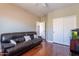 Spacious living room featuring hardwood floors and a comfortable leather sofa for relaxation at 4264 S Columbine Way, Gold Canyon, AZ 85118