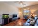Cozy living room featuring gleaming hardwood floors, a media center, and a scenic view at 4264 S Columbine Way, Gold Canyon, AZ 85118