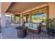 Cozy covered patio with comfortable seating and views of the landscaped backyard at 4264 S Columbine Way, Gold Canyon, AZ 85118