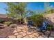 Relaxing patio area with stone pavers, comfortable seating, mature landscaping and shaded swing at 4264 S Columbine Way, Gold Canyon, AZ 85118