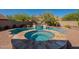 Backyard pool and spa featuring a sparkling pool, hot tub, lush landscaping, and a private oasis at 4264 S Columbine Way, Gold Canyon, AZ 85118