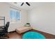 Bedroom with dark wood floors, ceiling fan, and sunny window at 4427 W Powell Dr, New River, AZ 85087