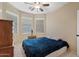 Comfortable bedroom with a ceiling fan and three large windows at 4427 W Powell Dr, New River, AZ 85087