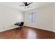Bedroom with dark wood floors, ceiling fan, and bright window at 4427 W Powell Dr, New River, AZ 85087