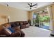 Bright living room featuring a plush leather sectional sofa and sliding glass doors to the backyard at 4427 W Powell Dr, New River, AZ 85087