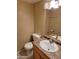 Cozy bathroom featuring a vanity with a sink and a mirror, toilet, and neutral wall and floor tiles at 4615 N 39Th Ave # 21, Phoenix, AZ 85019
