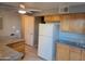 Bright kitchen with light wood cabinets, white appliances and stone-look countertops, with an open design at 4615 N 39Th Ave # 21, Phoenix, AZ 85019