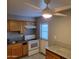 Bright kitchen featuring an oven, stone-look countertops, tile floors, and a modern ceiling fan at 4615 N 39Th Ave # 21, Phoenix, AZ 85019