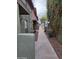 Exterior view of a long sidewalk leading to townhomes featuring greenery at 4615 N 39Th Ave # 21, Phoenix, AZ 85019