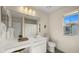 Bright bathroom showcasing a white double vanity, large mirror, a window and tiled floors, designed for both comfort and style at 4656 E Beck Ln, Phoenix, AZ 85032