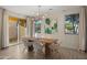 Bright dining room with a modern light fixture, a wood table, and access to the backyard at 4656 E Beck Ln, Phoenix, AZ 85032