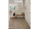 Bright entryway featuring wood-look tile, a wooden bench, and white staircase at 4656 E Beck Ln, Phoenix, AZ 85032