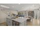 Open kitchen with a large island, stainless steel appliances, and an adjoining dining area at 4656 E Beck Ln, Phoenix, AZ 85032
