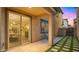 Exterior patio with paver flooring and adjacent grass, as well as a large sliding glass door to the home's interior at 4656 E Beck Ln, Phoenix, AZ 85032