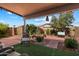 Inviting backyard with patio area, mature trees, and well-maintained landscaping at 481 S San Marcos Dr, Apache Junction, AZ 85120