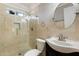 Bathroom with a glass door shower, stylish vanity and marble-look tile at 481 S San Marcos Dr, Apache Junction, AZ 85120