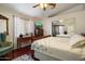 Bedroom with wood floors and dresser, mirrored closet doors and a large window for plenty of light at 481 S San Marcos Dr, Apache Junction, AZ 85120