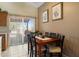 Cozy dining room with a wooden table, seating for six, and a sliding glass door to the yard at 481 S San Marcos Dr, Apache Junction, AZ 85120