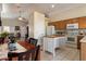 Open-concept kitchen and dining area, with wooden cabinets and a kitchen island at 481 S San Marcos Dr, Apache Junction, AZ 85120