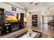 Comfortable living room with a large entertainment center, tile floors, and neutral colors at 481 S San Marcos Dr, Apache Junction, AZ 85120