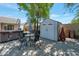 Private backyard featuring a hot tub, storage shed, and outdoor seating area at 6707 E Beverly Ln, Scottsdale, AZ 85254