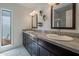 Bathroom featuring double sinks with dark wood cabinetry and granite countertops at 6707 E Beverly Ln, Scottsdale, AZ 85254