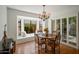 Cozy dining area with bay window seating, plantation shutters, and a modern chandelier at 6707 E Beverly Ln, Scottsdale, AZ 85254