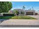 Stylish modern home with a desert landscaped front yard and a two-car garage with palm trees at 6707 E Beverly Ln, Scottsdale, AZ 85254