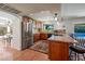 Bright kitchen with stainless steel appliances, ample cabinet space, and a view of the backyard pool at 6707 E Beverly Ln, Scottsdale, AZ 85254