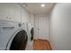 Convenient laundry room with washer, dryer, and white storage cabinets at 6707 E Beverly Ln, Scottsdale, AZ 85254