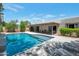 Beautiful backyard pool with lounge chairs and a covered patio area at 6707 E Beverly Ln, Scottsdale, AZ 85254