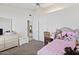 This bedroom has a ceiling fan, a walk-in closet, and carpet flooring at 6719 W Kerry Ln, Glendale, AZ 85308