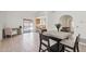 Open dining area featuring tile floors, a modern dining table, and views of the backyard pool area at 6719 W Kerry Ln, Glendale, AZ 85308
