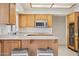 Kitchen features wood cabinets, stainless steel appliances and breakfast bar with seating for casual dining at 6719 W Kerry Ln, Glendale, AZ 85308