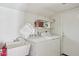 The laundry room has a laundry sink, washer, dryer, and storage shelves at 6719 W Kerry Ln, Glendale, AZ 85308