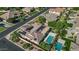 Aerial view of the home with solar panels, a pool, and a three-car garage in a residential neighborhood at 6917 E Ingram Cir, Mesa, AZ 85207