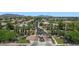 Panoramic aerial view of a gated community featuring lush landscaping and mountain views in the distance at 6917 E Ingram Cir, Mesa, AZ 85207