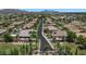 Expansive aerial view of a planned community showcasing well-manicured lawns and beautiful landscaping at 6917 E Ingram Cir, Mesa, AZ 85207