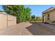 Spacious backyard features low-maintenance gravel, mature trees, and a storage shed at 6917 E Ingram Cir, Mesa, AZ 85207