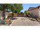 Gated backyard showcasing desert landscaping with a gravel and stone ground cover at 6917 E Ingram Cir, Mesa, AZ 85207